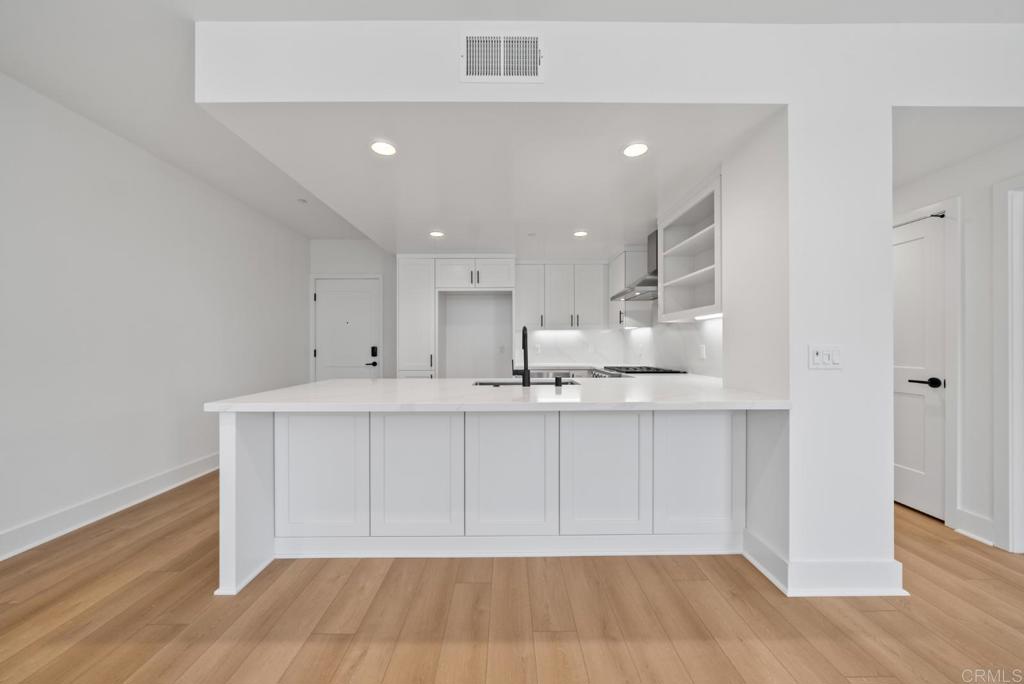 1101 Catania, Unit 104 Encinitas, CA 92024 - Photo 8 of 41 a view of kitchen with wooden floor
