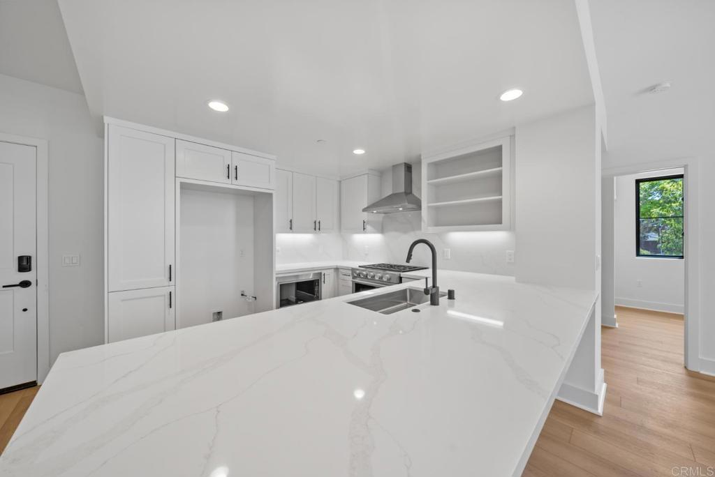 1101 Catania, Unit 104 Encinitas, CA 92024 - Photo 9 of 41 a kitchen with granite countertop a sink a window and stainless steel appliances