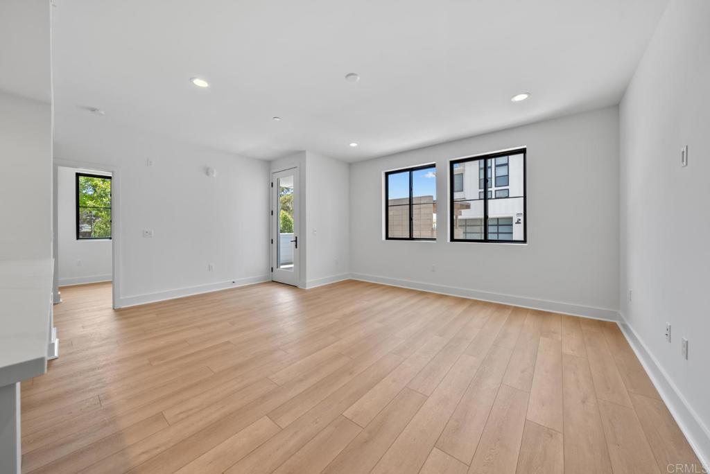 1101 Catania, Unit 104 Encinitas, CA 92024 - Photo 10 of 41 a view of empty room with wooden floor and fan