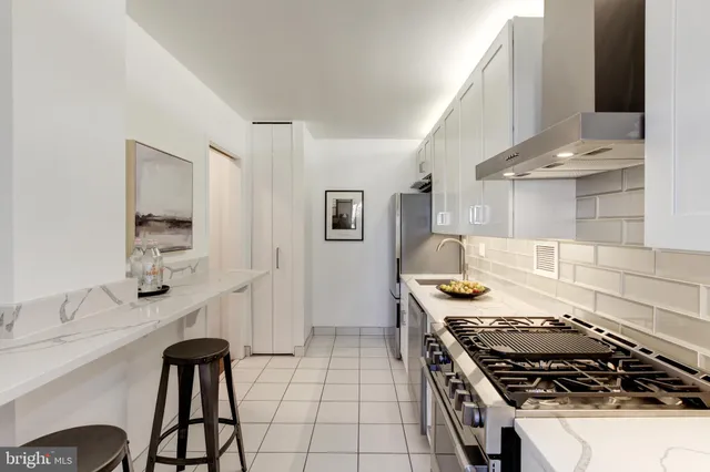 a kitchen with stainless steel appliances granite countertop a stove and a sink