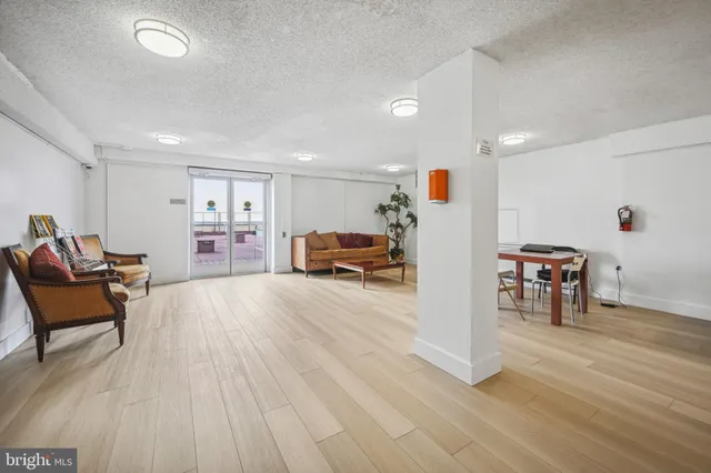 a view of a cafe with a table and chairs under an umbrella