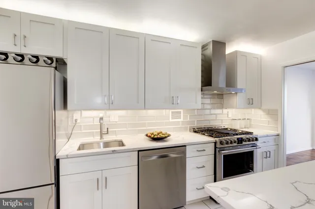 a living room with furniture and a book shelf