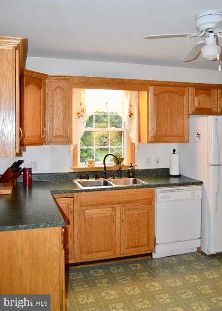 1450 Stringtown Road Berryville, VA 22611 - Photo 5 of 13 a kitchen with stainless steel appliances granite countertop a sink a stove and a refrigerator
