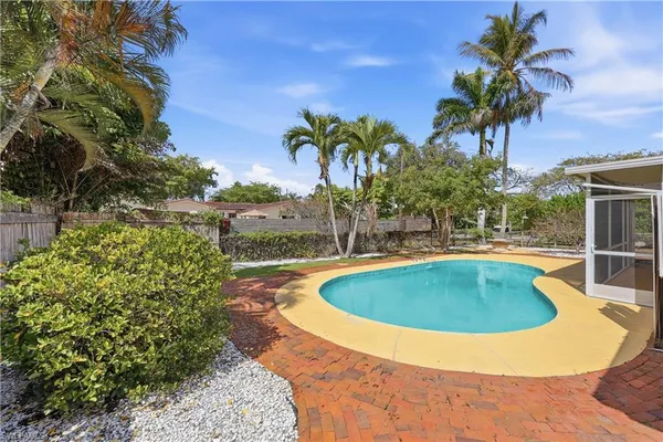 a view of a swimming pool with a yard