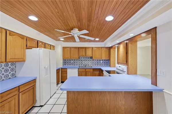 a kitchen with a sink a refrigerator and window