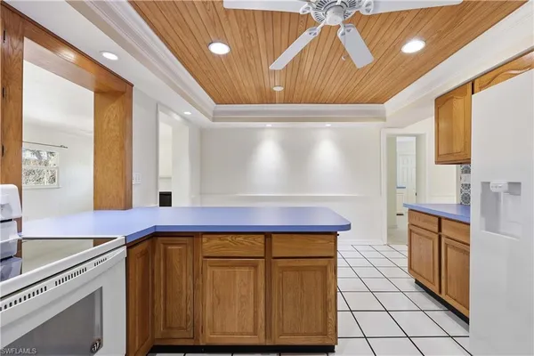 a view of a kitchen with cabinets and wooden floor
