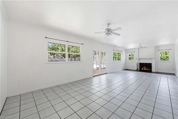 a view of livingroom with furniture fireplace and window
