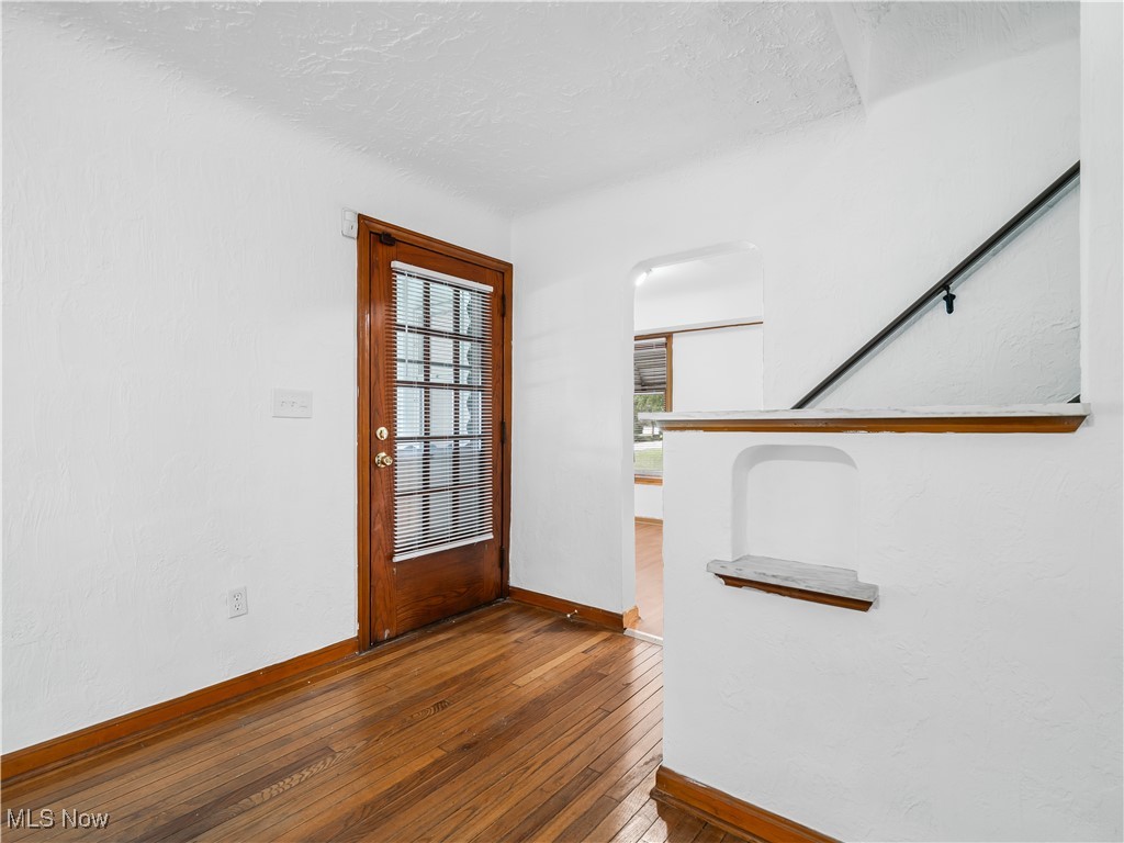 3605 Center Road Avon, OH 44011 - Photo 6 of 34 Foyer entrance with dark wood-type flooring and a textured ceiling