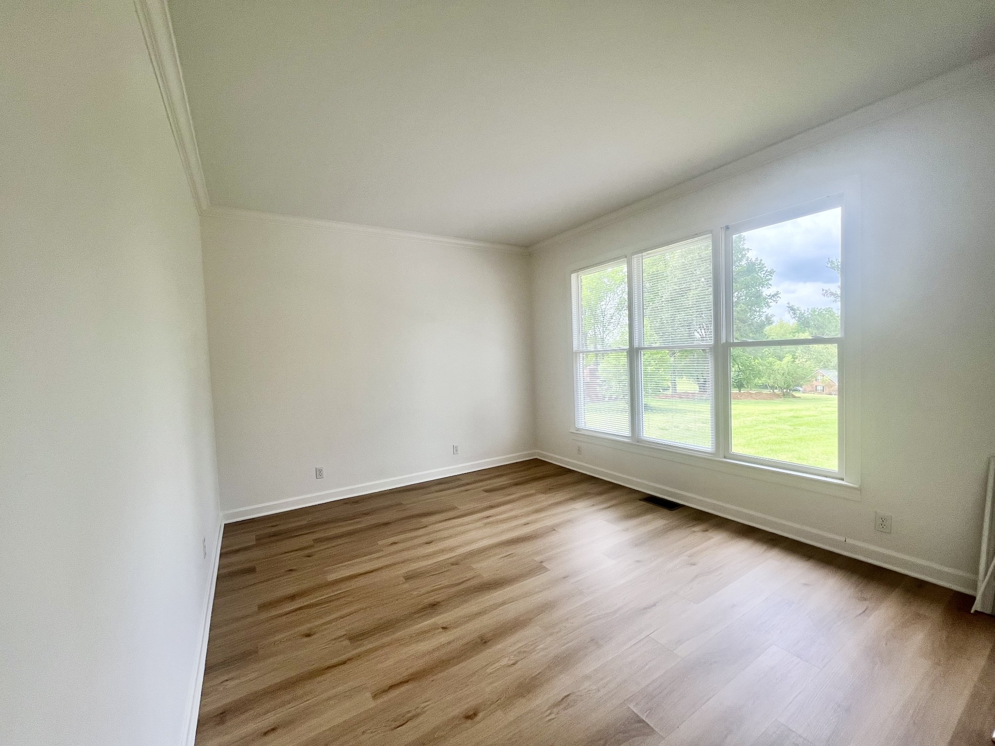 650 Vanderbilt Road Mount Juliet, TN 37122 - Photo 32 of 45 an empty room with wooden floor and windows