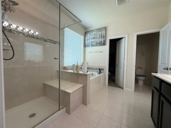 a en suite bathroom with a double vanity sink a mirror and a shower