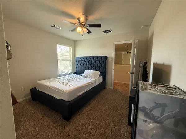 a bedroom with a bed and window