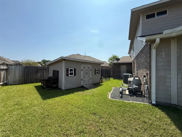 a swimming pool with outdoor seating yard and barbeque oven