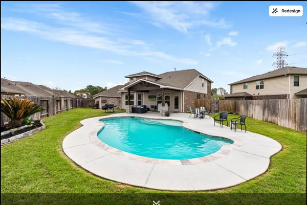 a view of a house with swimming pool and a yard