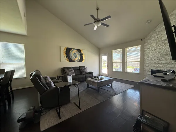 a living room with furniture a fireplace and a flat screen tv