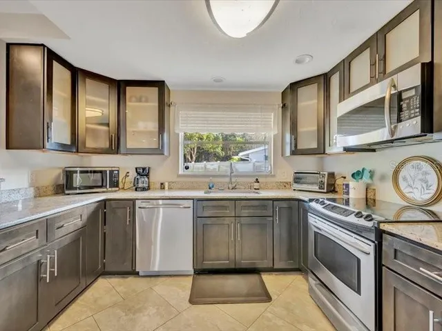 a kitchen with a sink stove and cabinets
