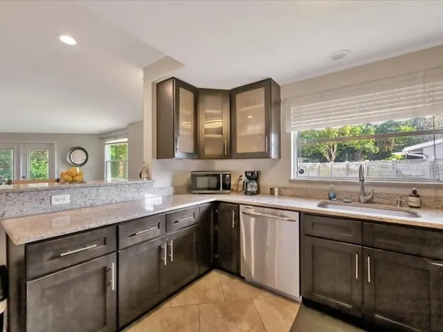 a kitchen with a sink stove and cabinets