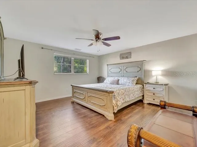 a spacious bedroom with a bed and a chandelier