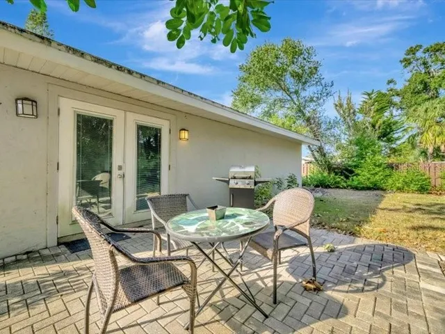 a outdoor space with a table and chairs