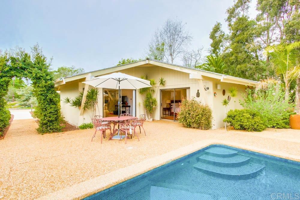 17355 Avenida De Acacias Rancho Santa Fe, CA 92067 - Photo 3 of 16 a view of a patio with table and chairs under an umbrella