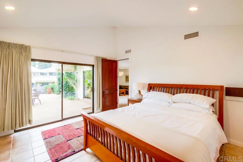 17355 Avenida De Acacias Rancho Santa Fe, CA 92067 - Photo 7 of 16 a bedroom with a large bed and a large window