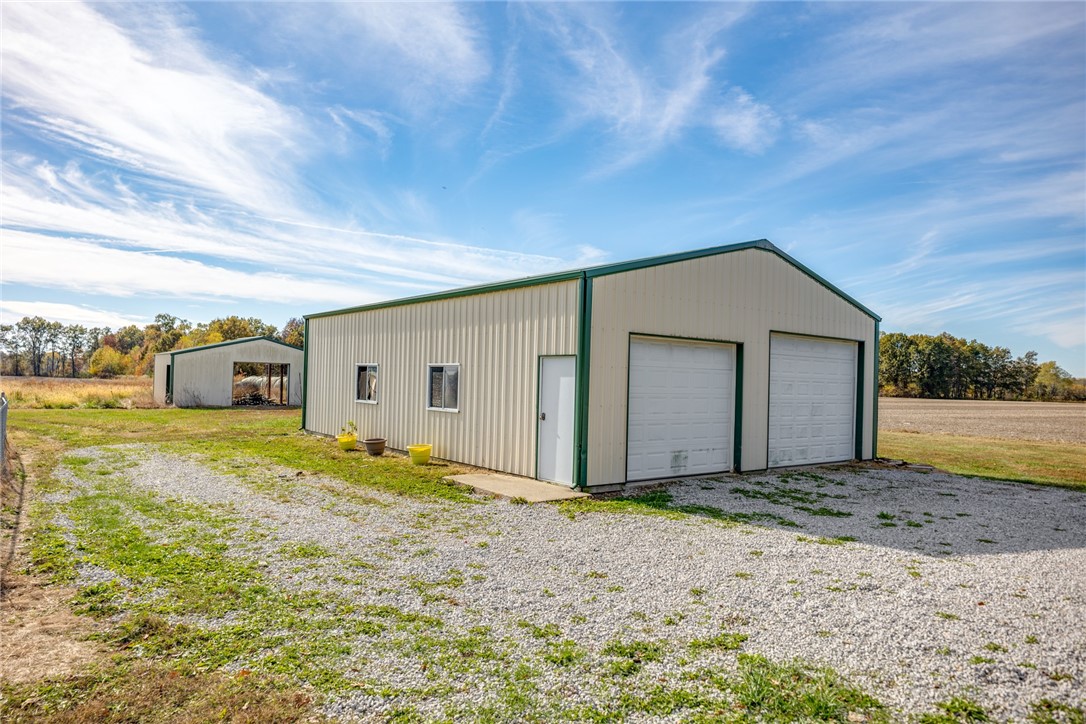 9118 Faye Road Kinmundy, IL 62854 - Photo 45 of 48 Pole Barn with two overhead doors, a side entrance door, and a back sliding door.