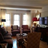 a living room with furniture fireplace and a window