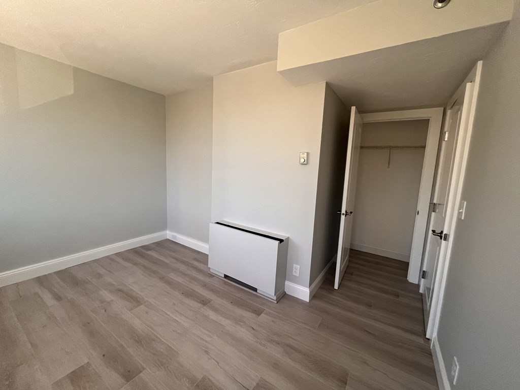 70 Southbridge Street, Unit 215 Worcester, MA 01608 - Photo 18 of 27 an empty room with wooden floor and a window