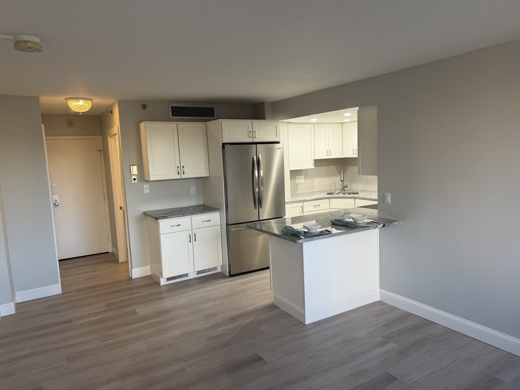 70 Southbridge Street, Unit 215 Worcester, MA 01608 - Photo 5 of 27 a kitchen with a refrigerator sink and cabinets