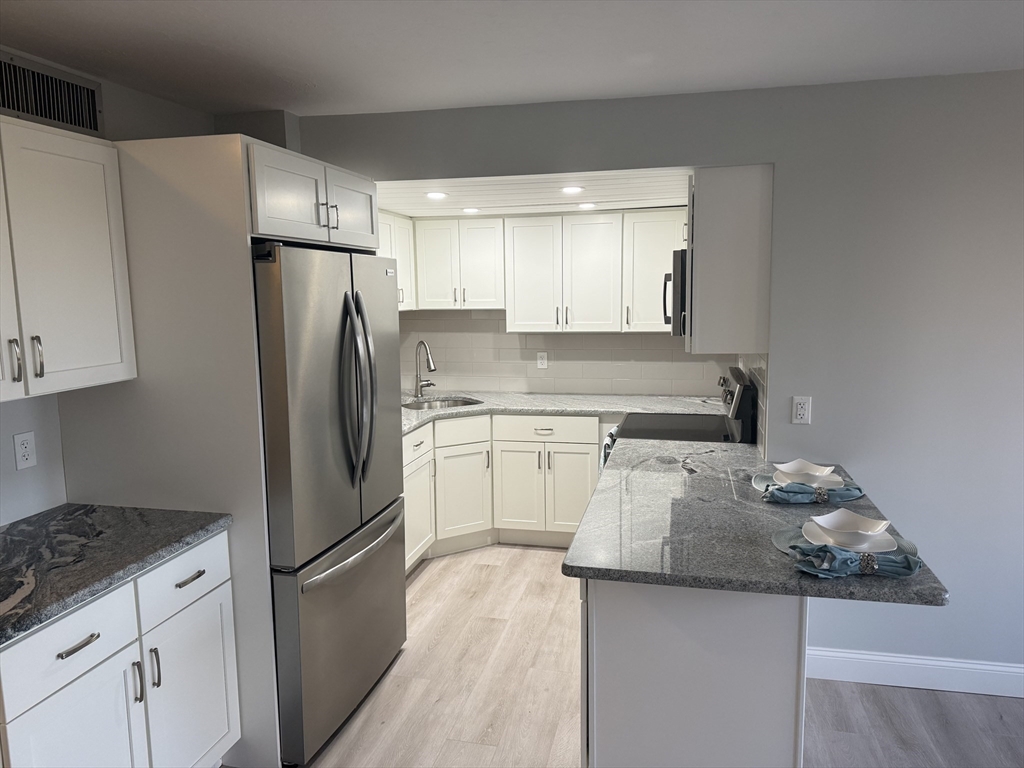 70 Southbridge Street, Unit 215 Worcester, MA 01608 - Photo 6 of 27 a kitchen with a refrigerator sink and stove