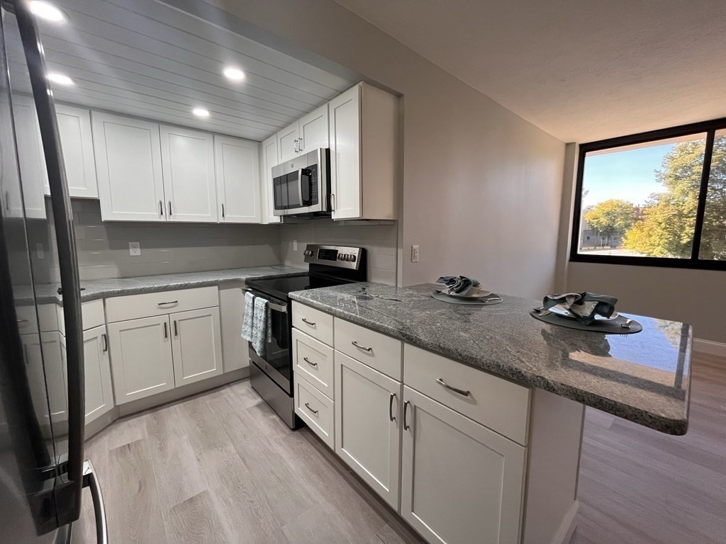 70 Southbridge Street, Unit 215 Worcester, MA 01608 - Photo 8 of 27 a kitchen with sink cabinets and appliances