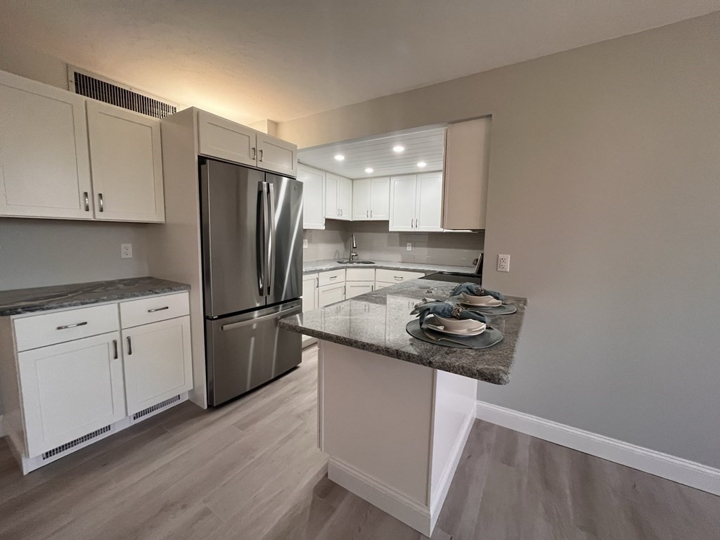 70 Southbridge Street, Unit 215 Worcester, MA 01608 - Photo 9 of 27 a kitchen with stainless steel appliances granite countertop a sink stove and refrigerator