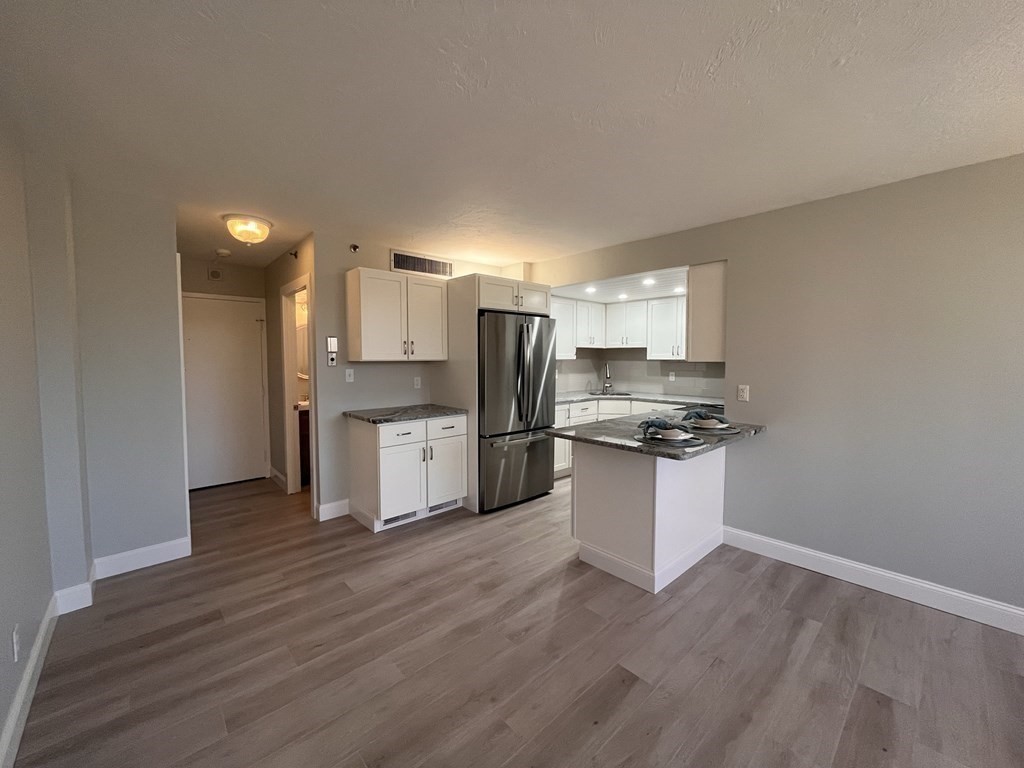 70 Southbridge Street, Unit 215 Worcester, MA 01608 - Photo 10 of 27 a kitchen with a refrigerator and a stove top oven