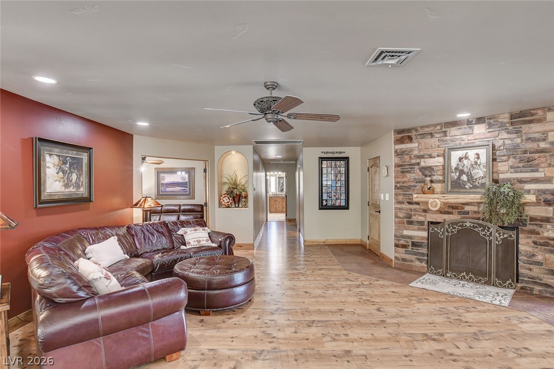 1950 Bowman Road Logandale, NV 89021 - Photo 11 of 81 A rustic great room offers a stone fireplace and warm wood flooring.