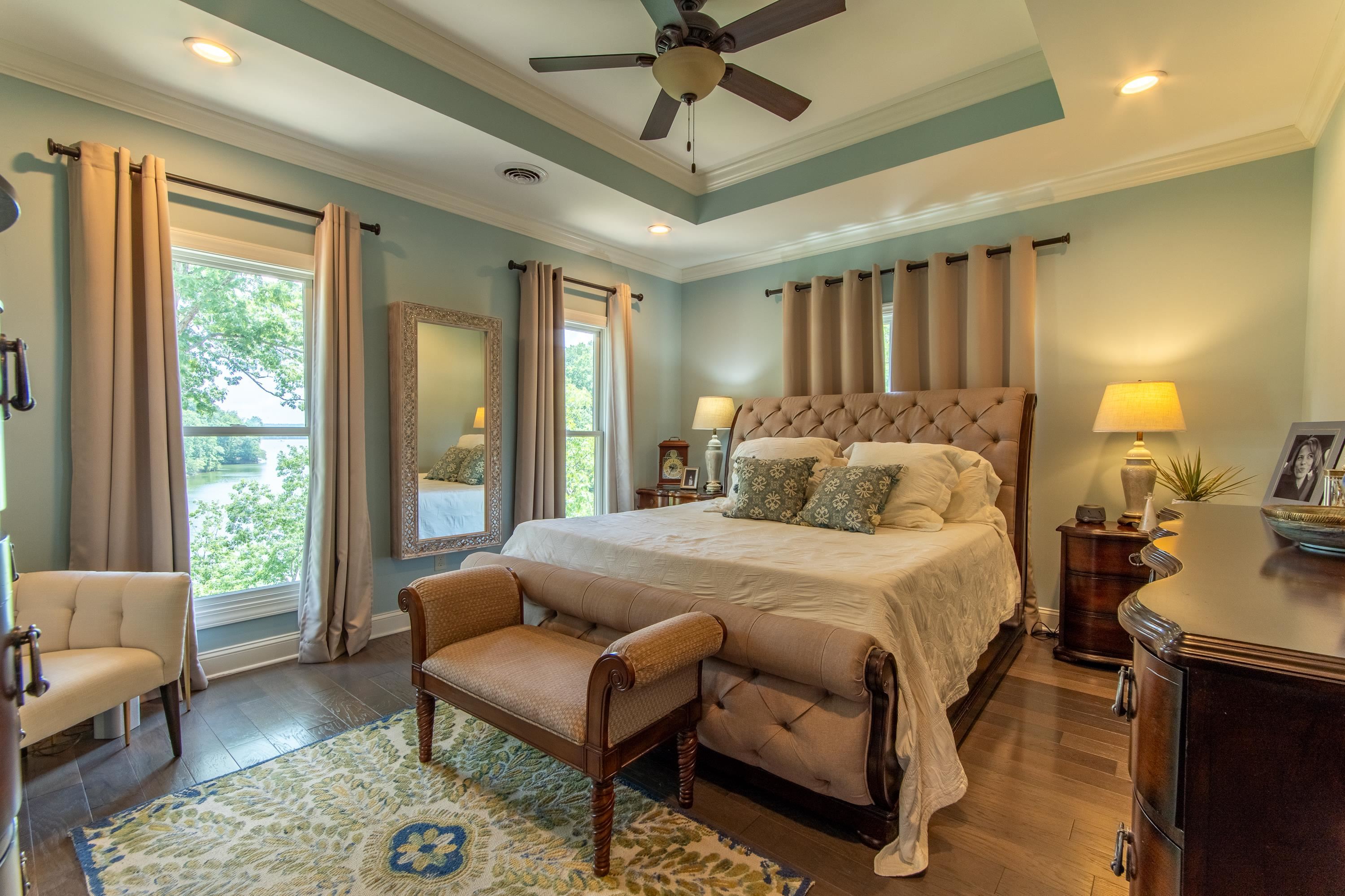55 Ridge Pointe Drive Savannah, TN 38372 - Photo 12 of 40 Bedroom featuring crown molding, dark hardwood / wood-style floors, ceiling fan, and a raised ceiling