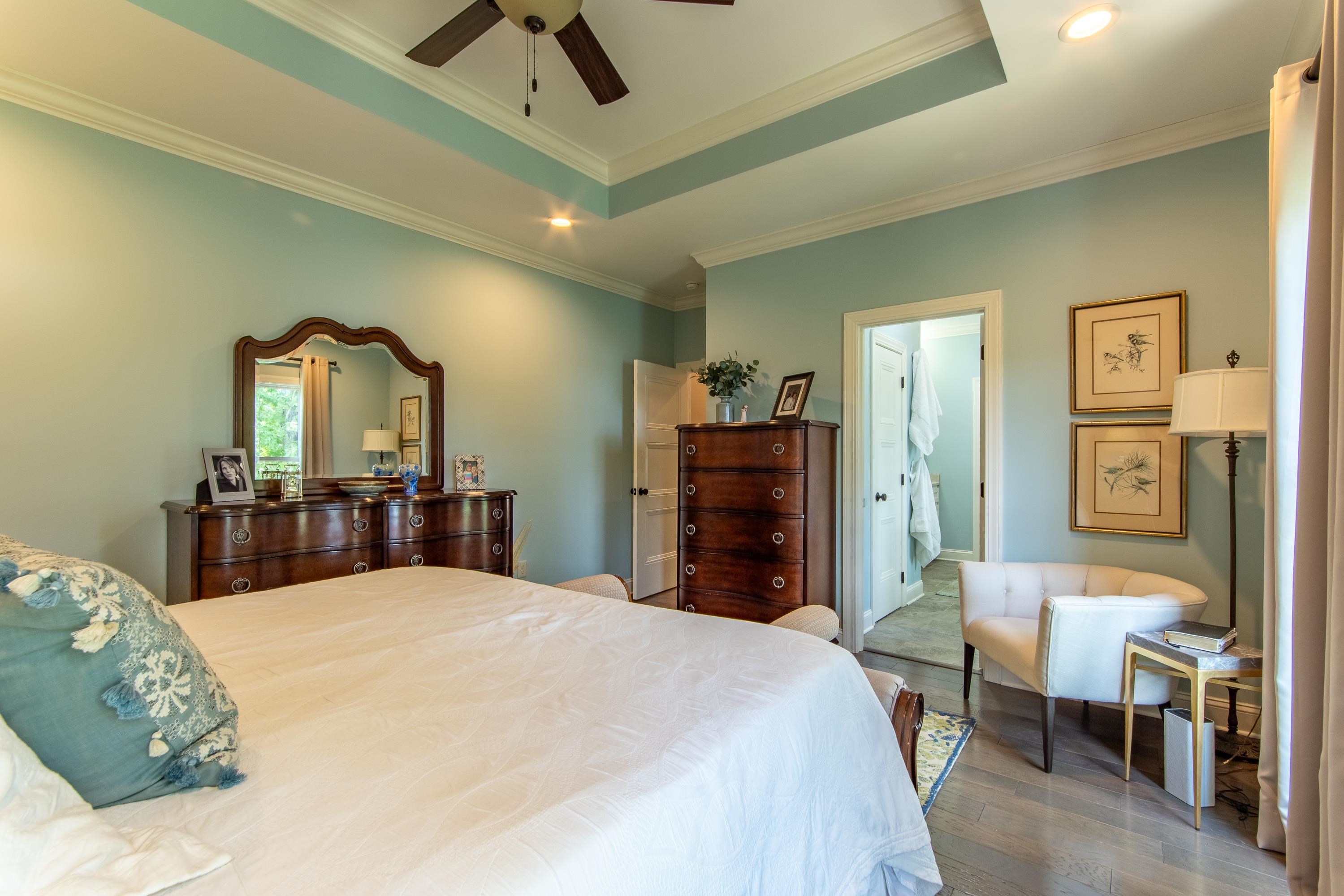 55 Ridge Pointe Drive Savannah, TN 38372 - Photo 13 of 40 Bedroom featuring connected bathroom, hardwood / wood-style flooring, ceiling fan, ornamental molding, and a raised ceiling