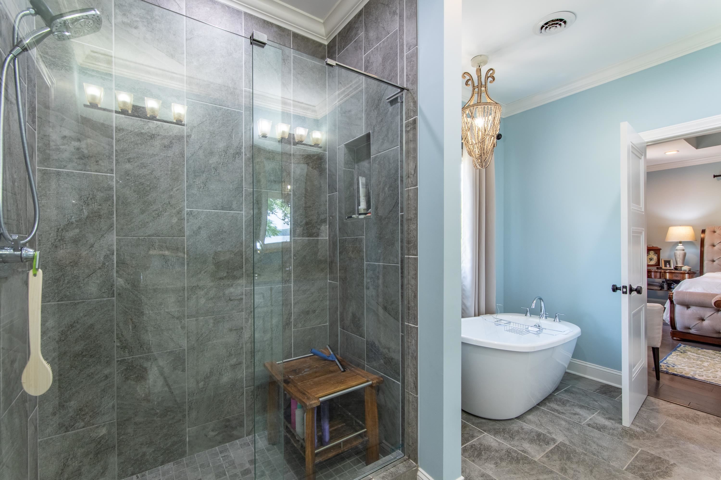 55 Ridge Pointe Drive Savannah, TN 38372 - Photo 16 of 40 Bathroom featuring a shower with shower door, tile patterned floors, and crown molding