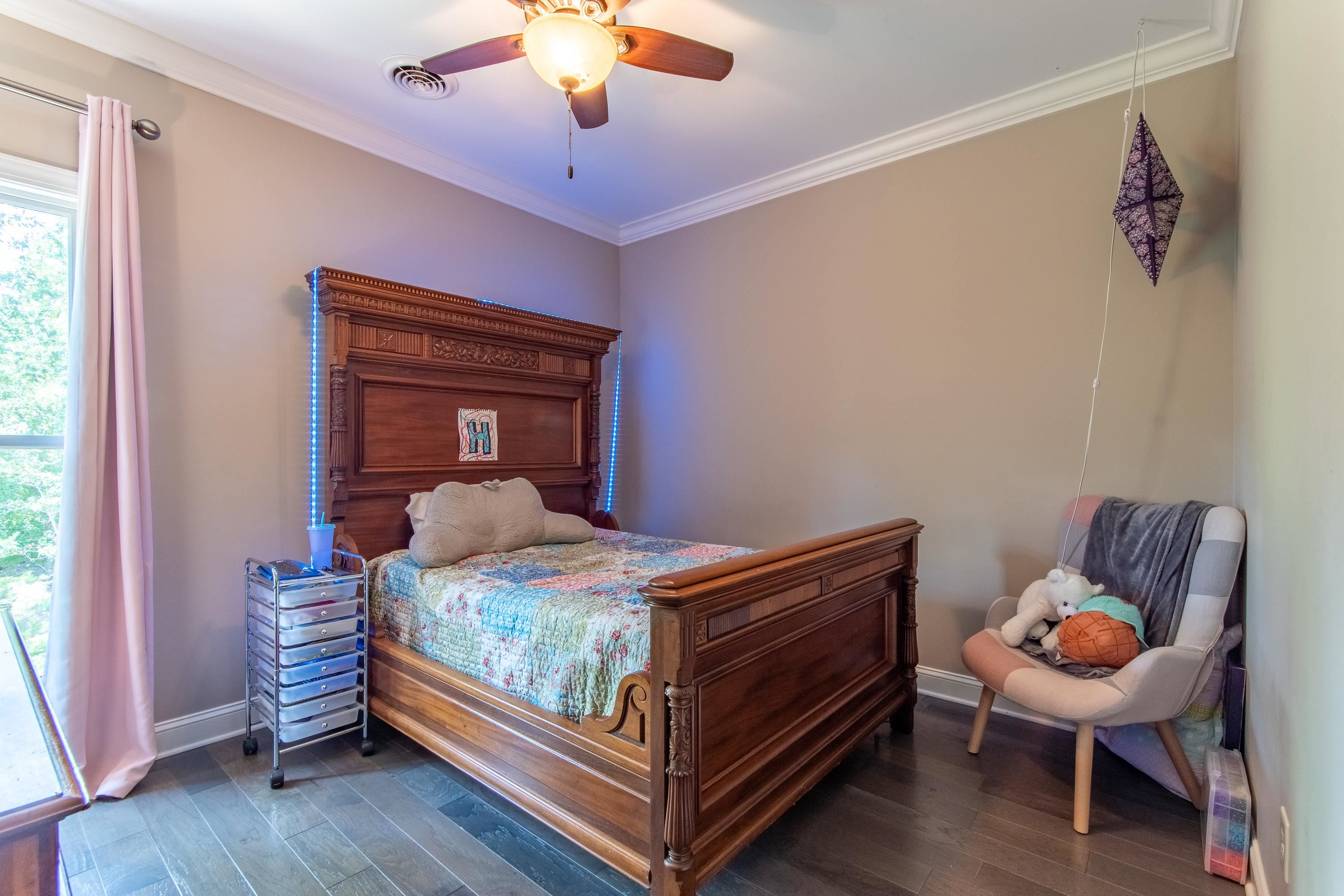 55 Ridge Pointe Drive Savannah, TN 38372 - Photo 18 of 40 Bedroom with ceiling fan, crown molding, and dark wood-type flooring