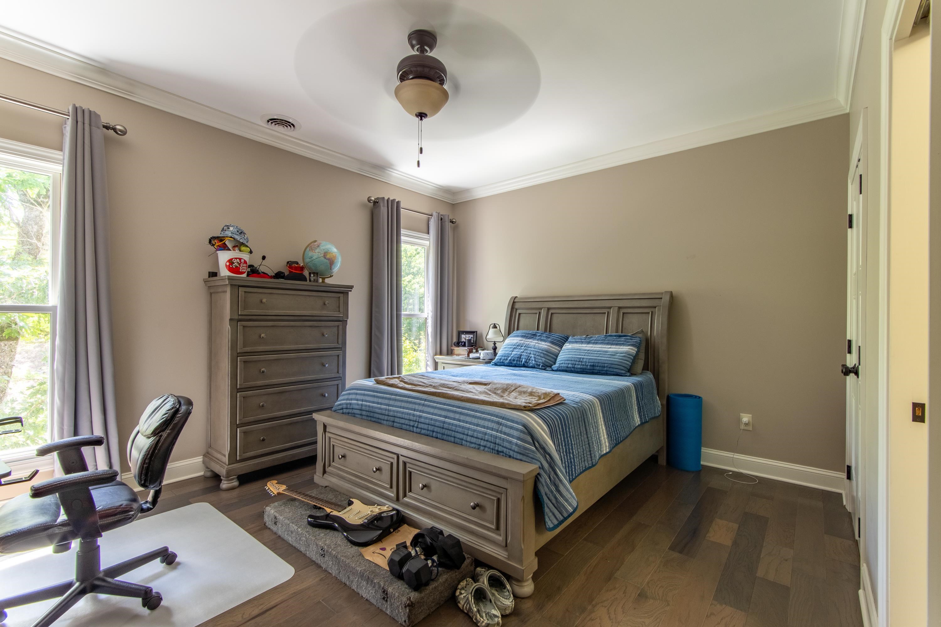 55 Ridge Pointe Drive Savannah, TN 38372 - Photo 22 of 40 Bedroom with crown molding, dark hardwood / wood-style floors, multiple windows, and ceiling fan
