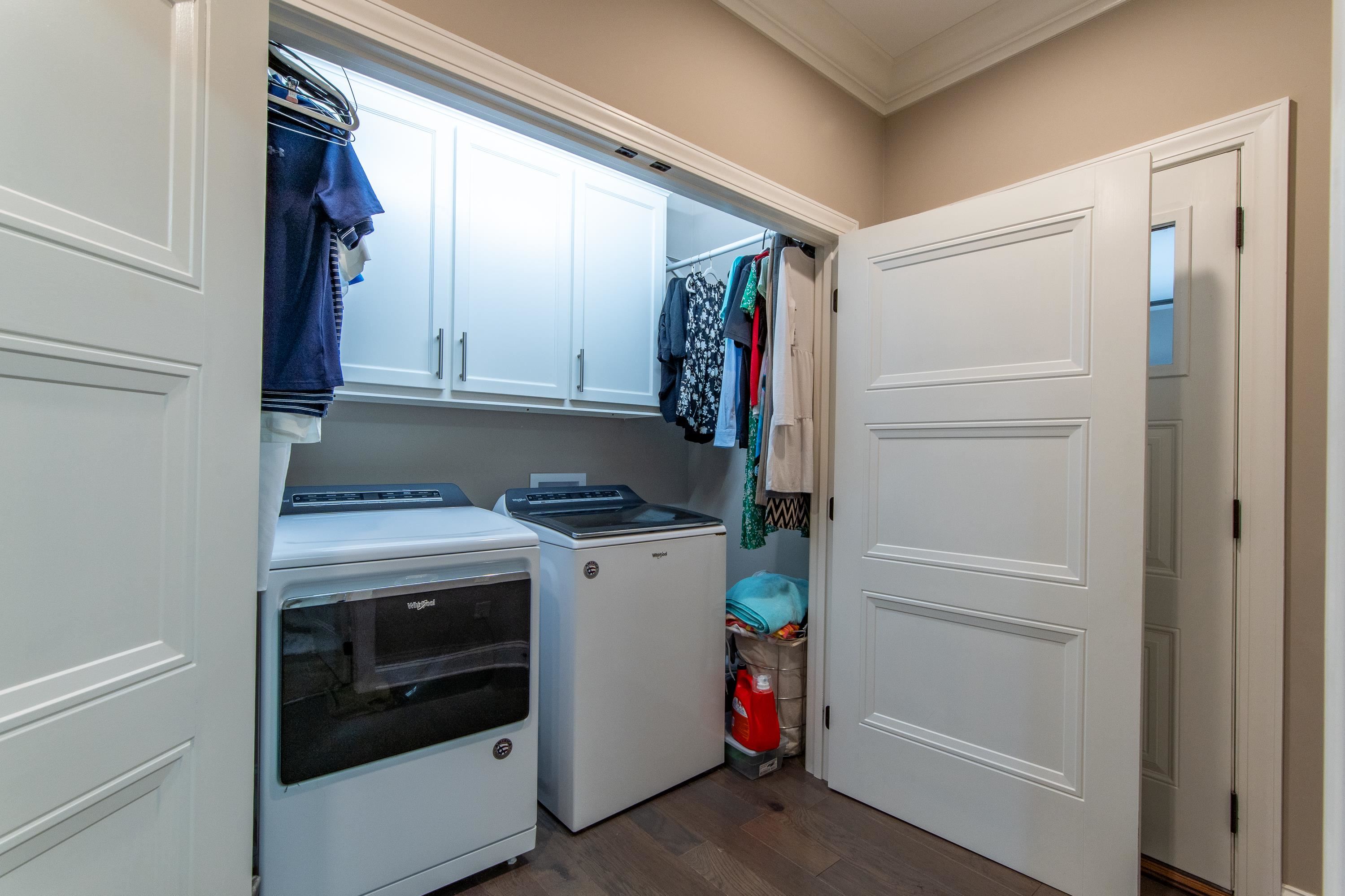 55 Ridge Pointe Drive Savannah, TN 38372 - Photo 30 of 40 Clothes washing area featuring washer and clothes dryer, dark hardwood / wood-style floors, cabinets, and ornamental molding