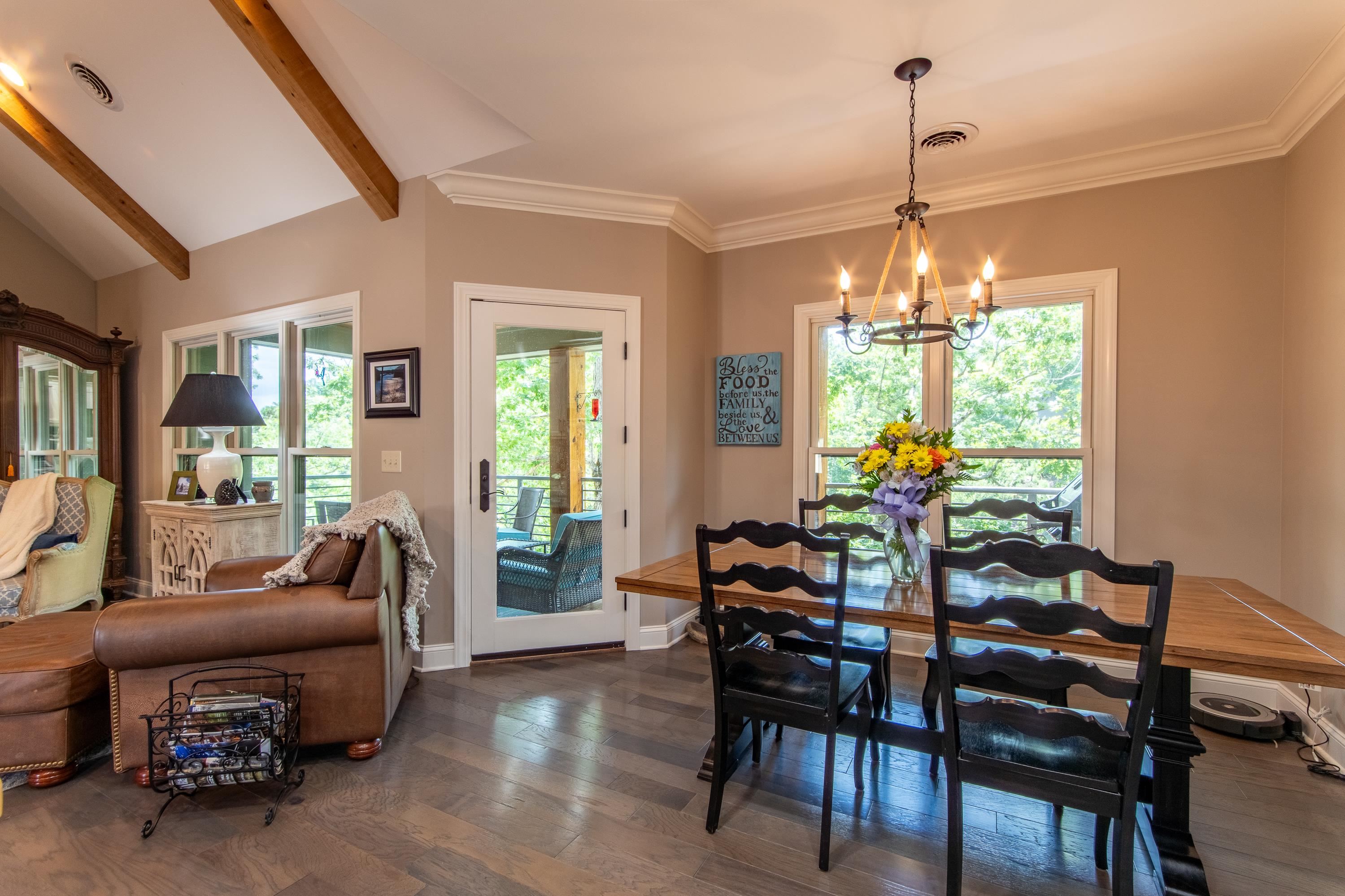 55 Ridge Pointe Drive Savannah, TN 38372 - Photo 6 of 40 Dining area featuring plenty of natural light, dark hardwood / wood-style flooring, a notable chandelier, and vaulted ceiling with beams