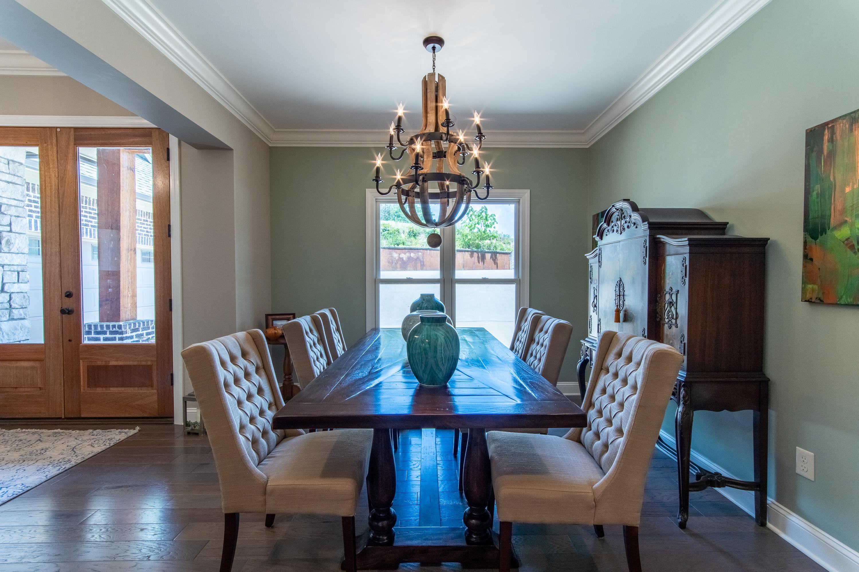 55 Ridge Pointe Drive Savannah, TN 38372 - Photo 8 of 40 Dining room with an inviting chandelier, crown molding, french doors, and dark hardwood / wood-style flooring
