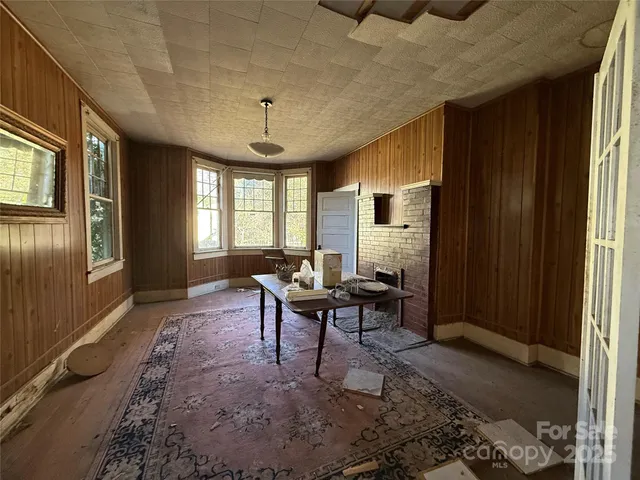 a living room with furniture a chandelier and a window