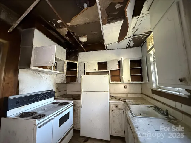 a kitchen with stainless steel appliances granite countertop a refrigerator and a stove