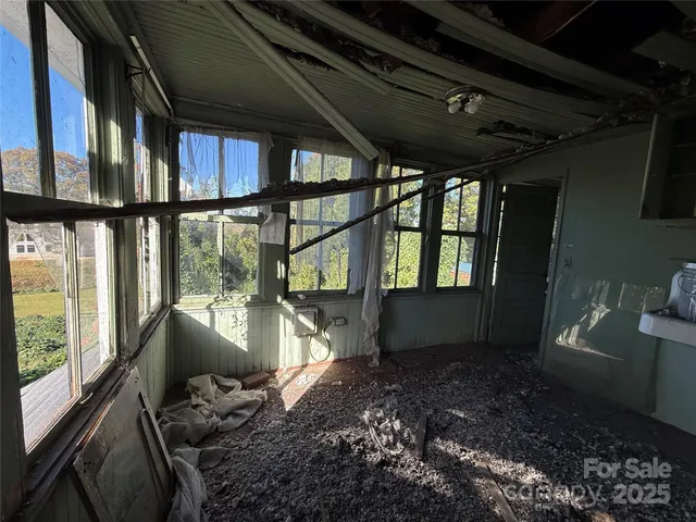 a view of a balcony with chair and wooden floor