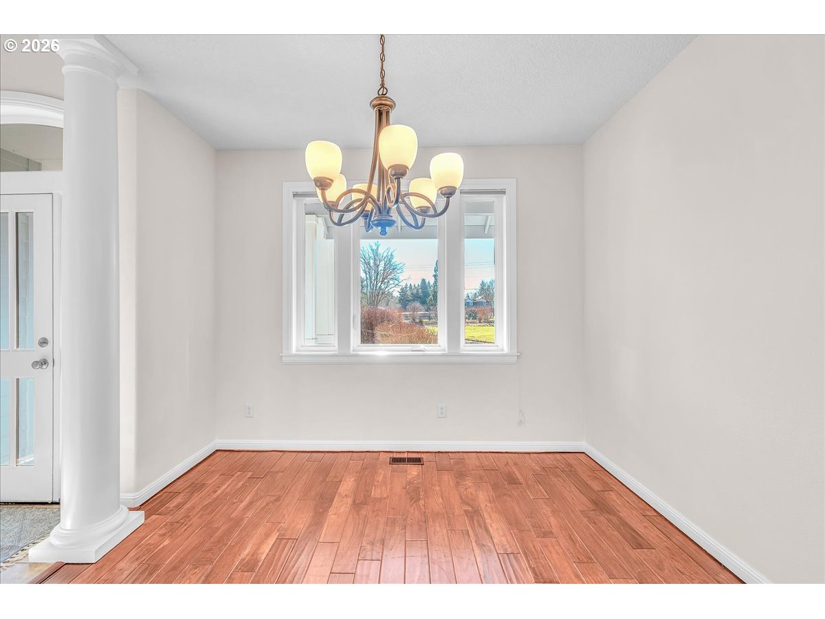 34043 Bennett Road Warren, OR 97053 - Photo 17 of 46 a view of an empty room with wooden floor and a window