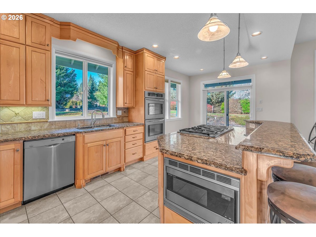 34043 Bennett Road Warren, OR 97053 - Photo 19 of 46 a kitchen with a stove a sink and a granite counter top
