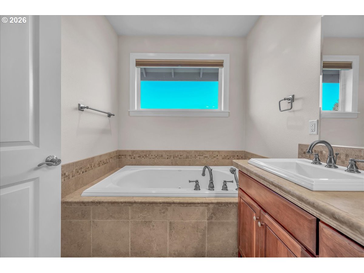34043 Bennett Road Warren, OR 97053 - Photo 33 of 46 a bathroom with a granite countertop sink window and mirror