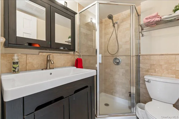 a bathroom with a sink toilet and shower
