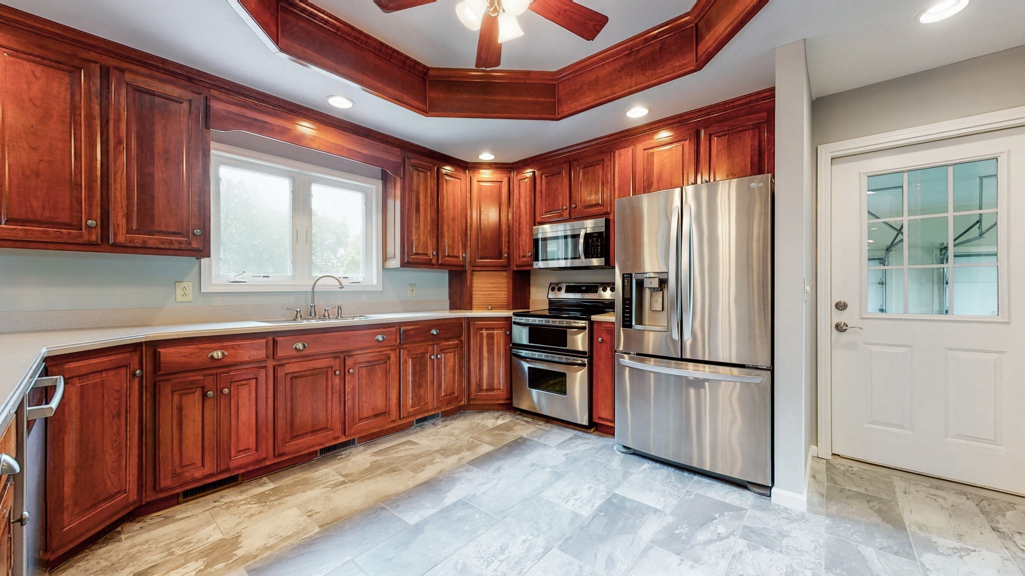 656 Greenvale Road Milton, TN 37118 - Photo 11 of 43 a kitchen with stainless steel appliances granite countertop a refrigerator a sink a stove a washer and dryer with wooden cabinets