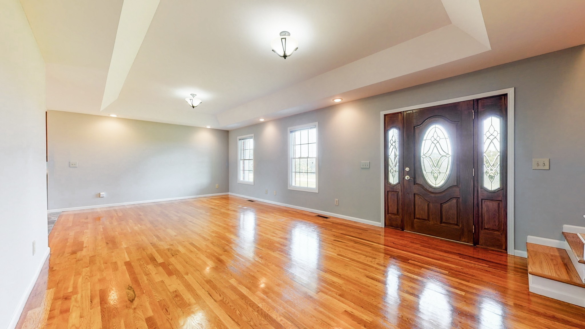 656 Greenvale Road Milton, TN 37118 - Photo 7 of 43 a view of an empty room with wooden floor and mirror